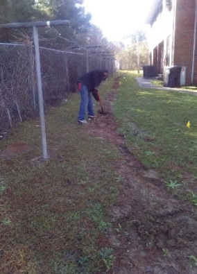 a man burying fiber cables