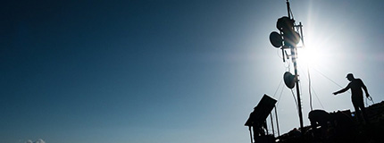 People putting up a tower for Internet access